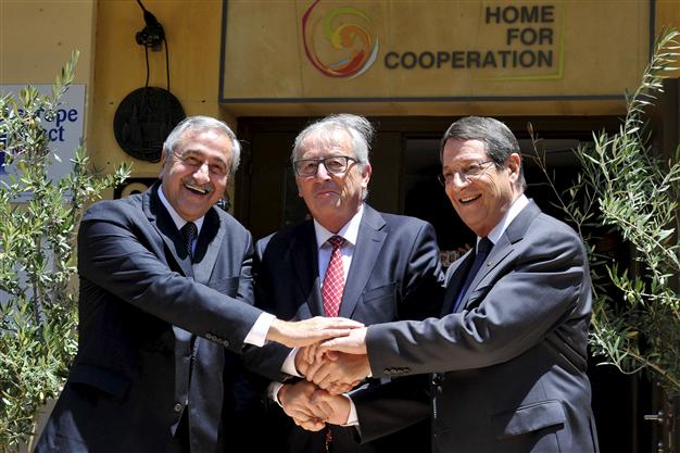L-R: Mustafa Akıncı, Jean-Claude Juncker & Nicos Anastasiades agree hellim deal, Nicosia, 16 July. Photo: Reuters
