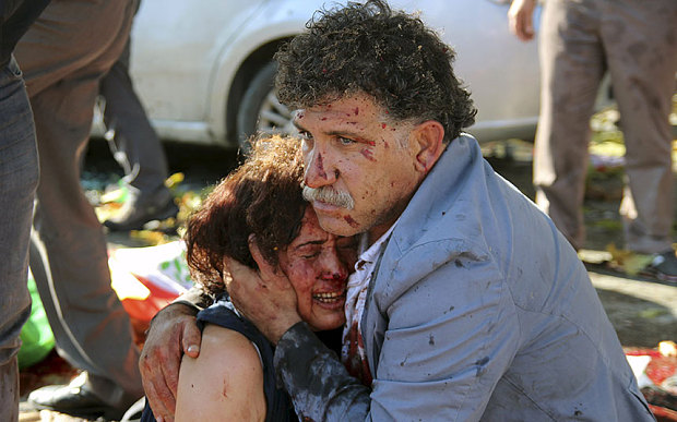 İzzettin Çevik cradles his wife after his sister & daughter are killed in the blast