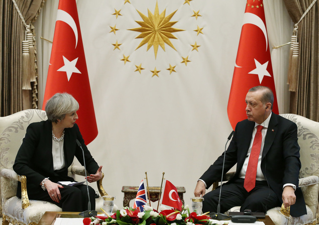Turkey's President Recep Tayyip Erdogan, right, talks with British Prime Minister Theresa May, during their meeting at the Presidential Palace in Ankara, Turkey, Saturday, Jan. 28, 2017. May on Saturday met with Erdogan, a day after a friendly meeting in Washington with U.S. President Donald Trump. (Presidential Press Service, Pool via AP)