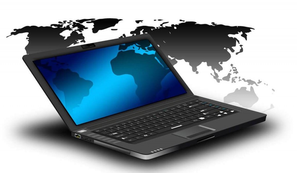 Open laptop overlaid with world map